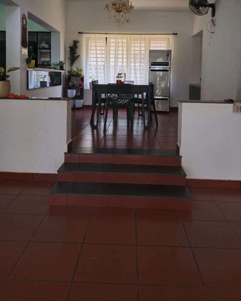 Modern dining area with step elevation and a unique circular ceiling accent.