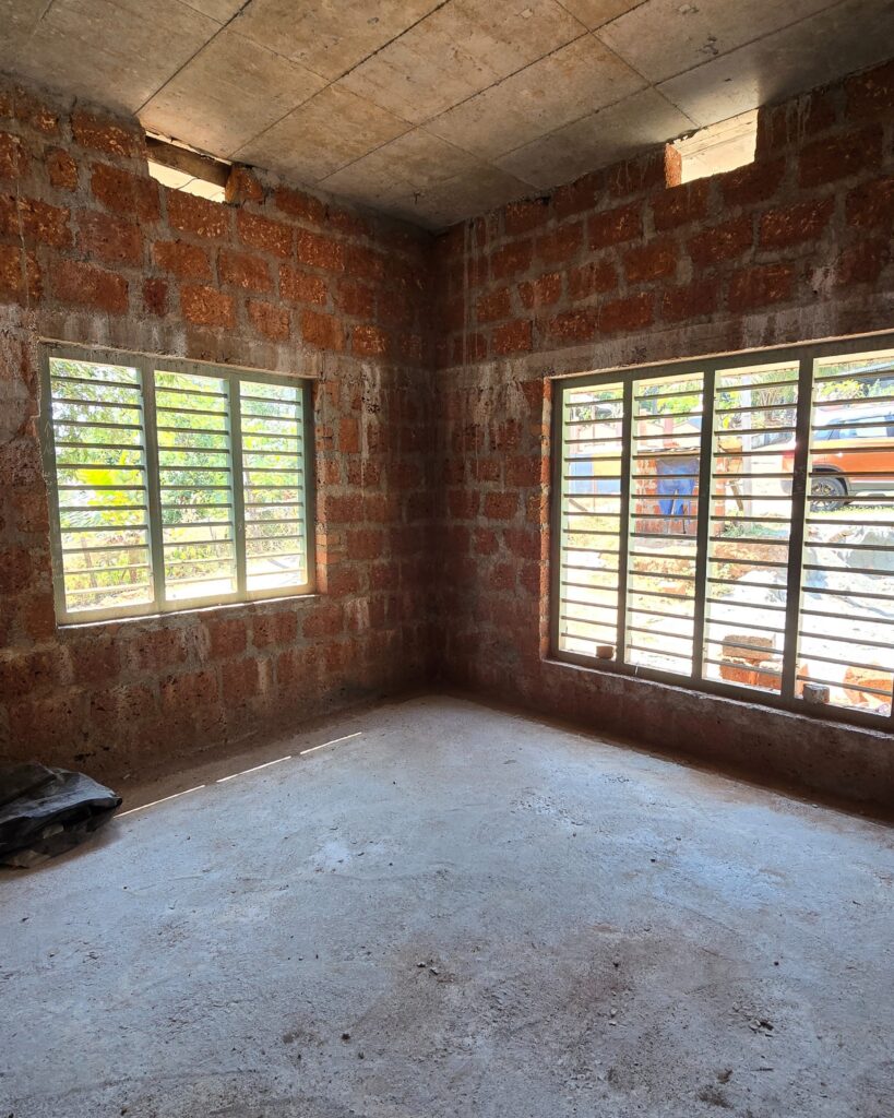 Spacious room with two large windows allowing ample natural light.